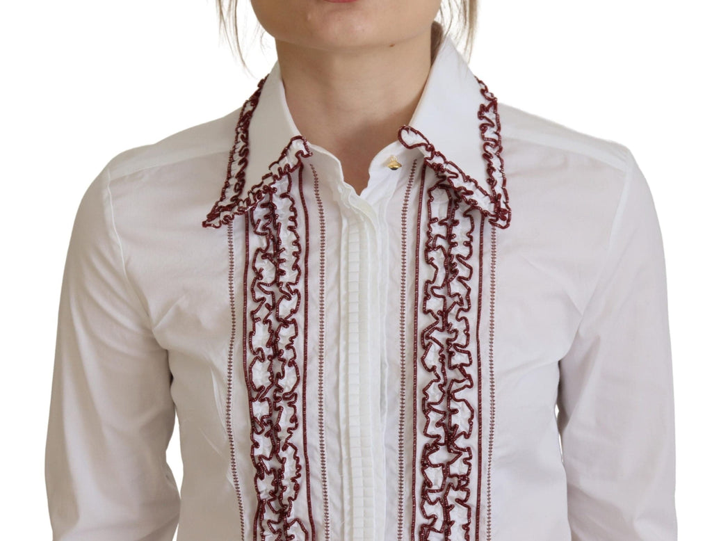 Chemise blanche en dentelle Dolce & Gabbana avec manches longues et col à volants, détails élégants et féminins.