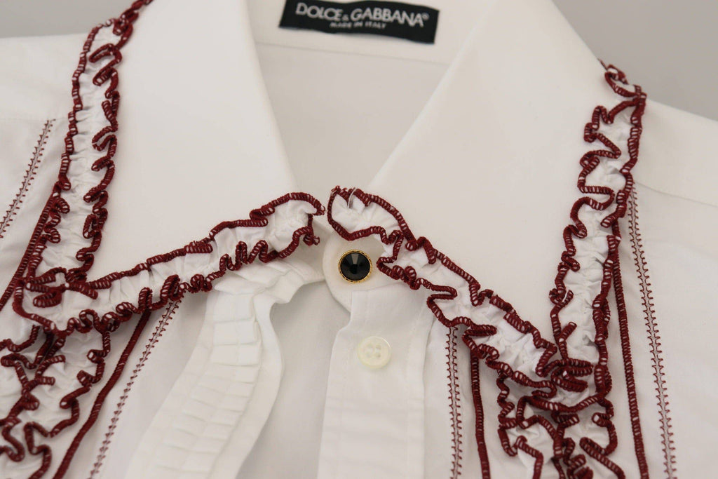 Chemise blanche Dolce & Gabbana en dentelle avec manches longues et col à volants, élégante et raffinée.