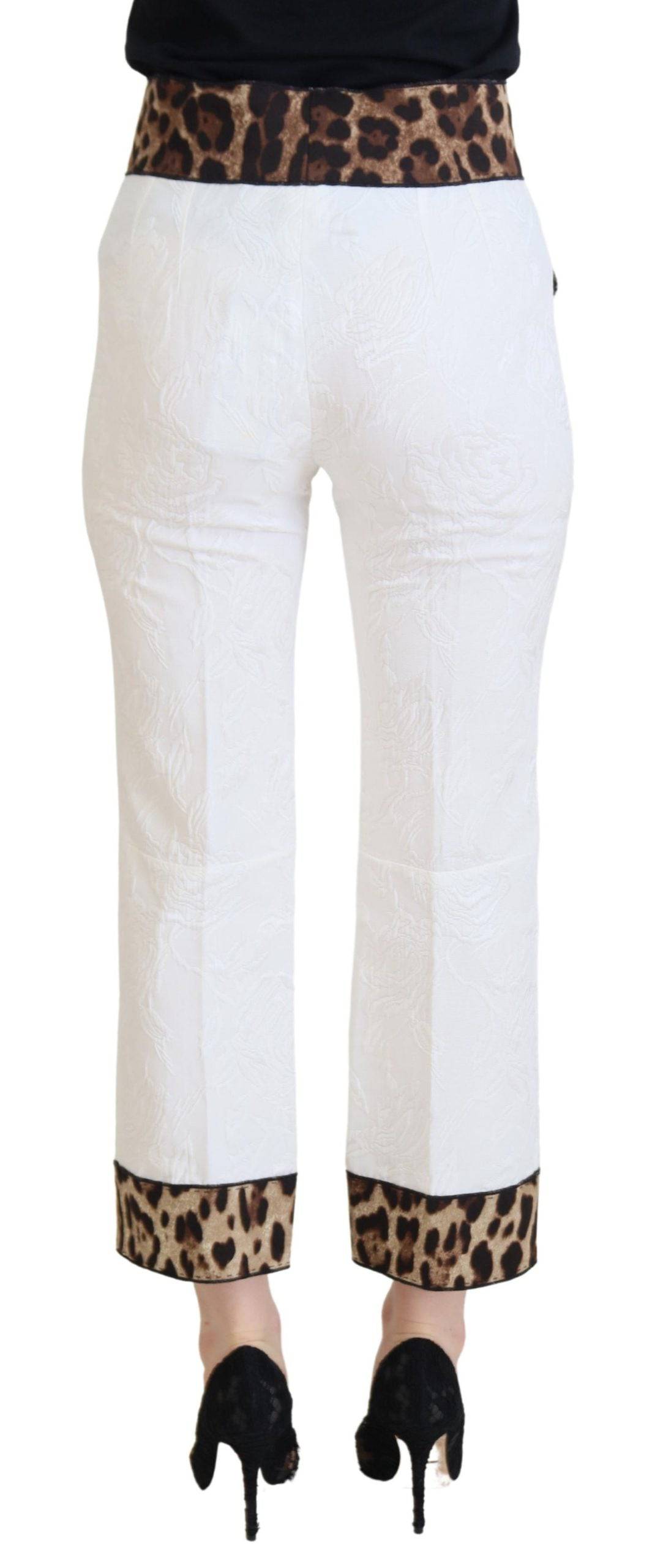 Pantalon blanc à taille haute Dolce & Gabbana avec imprimé léopard, tissu fluide et élégant pour un style sophistiqué.