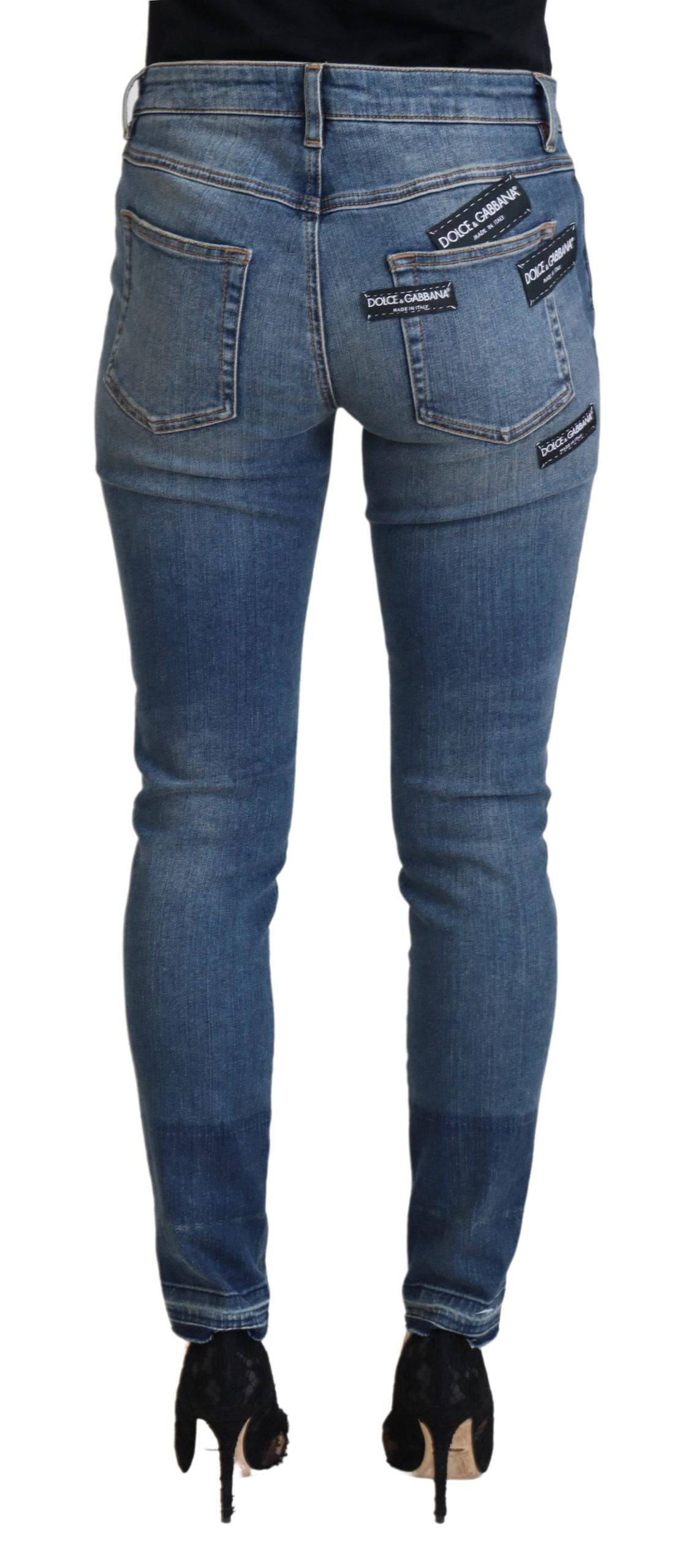 Jeans en denim délavé bleu Dolce & Gabbana, usés et déchirés, avec coupe décontractée et détails vintage.