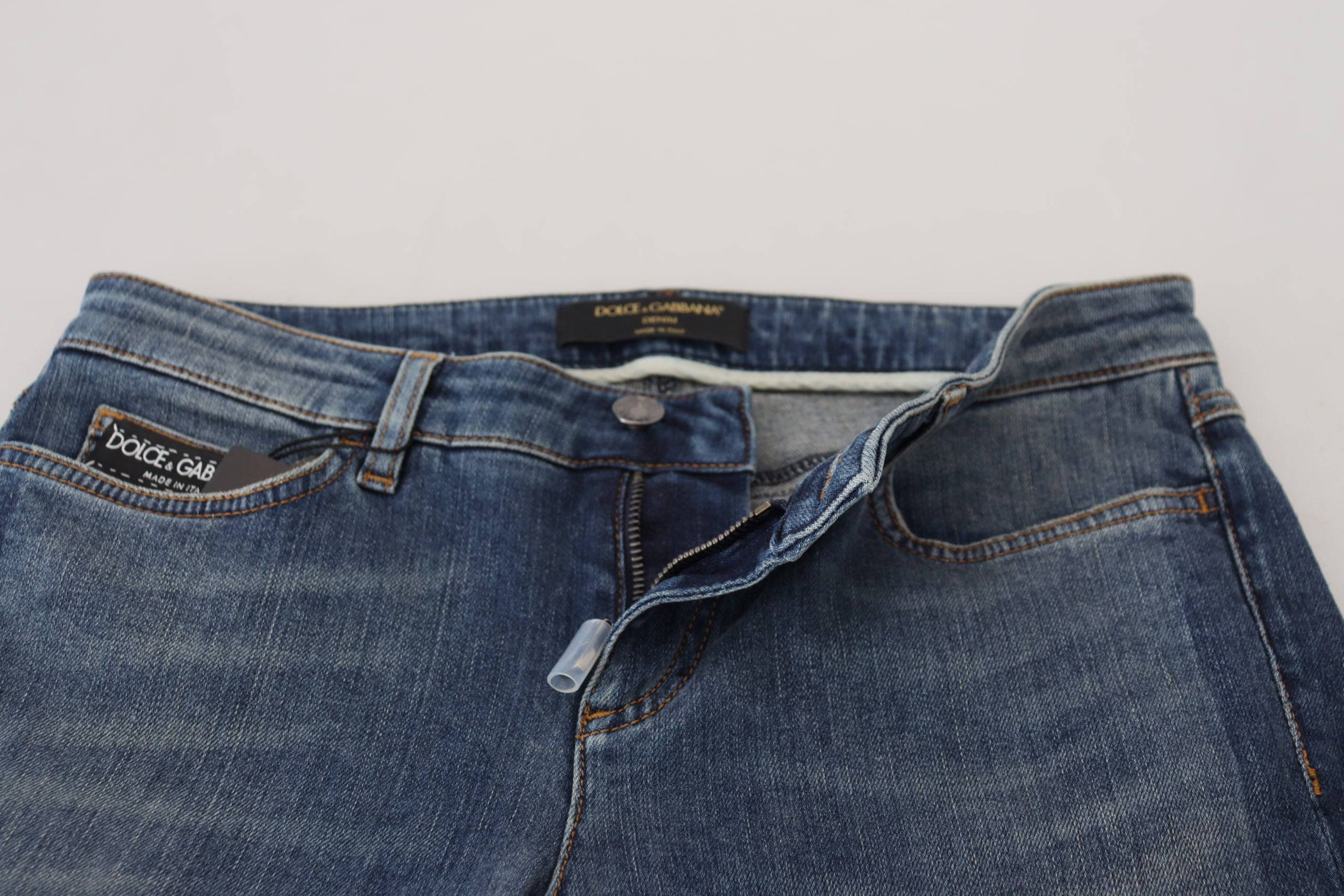 Jeans en denim délavé bleu Dolce & Gabbana avec déchirures et style usé, en coton.
