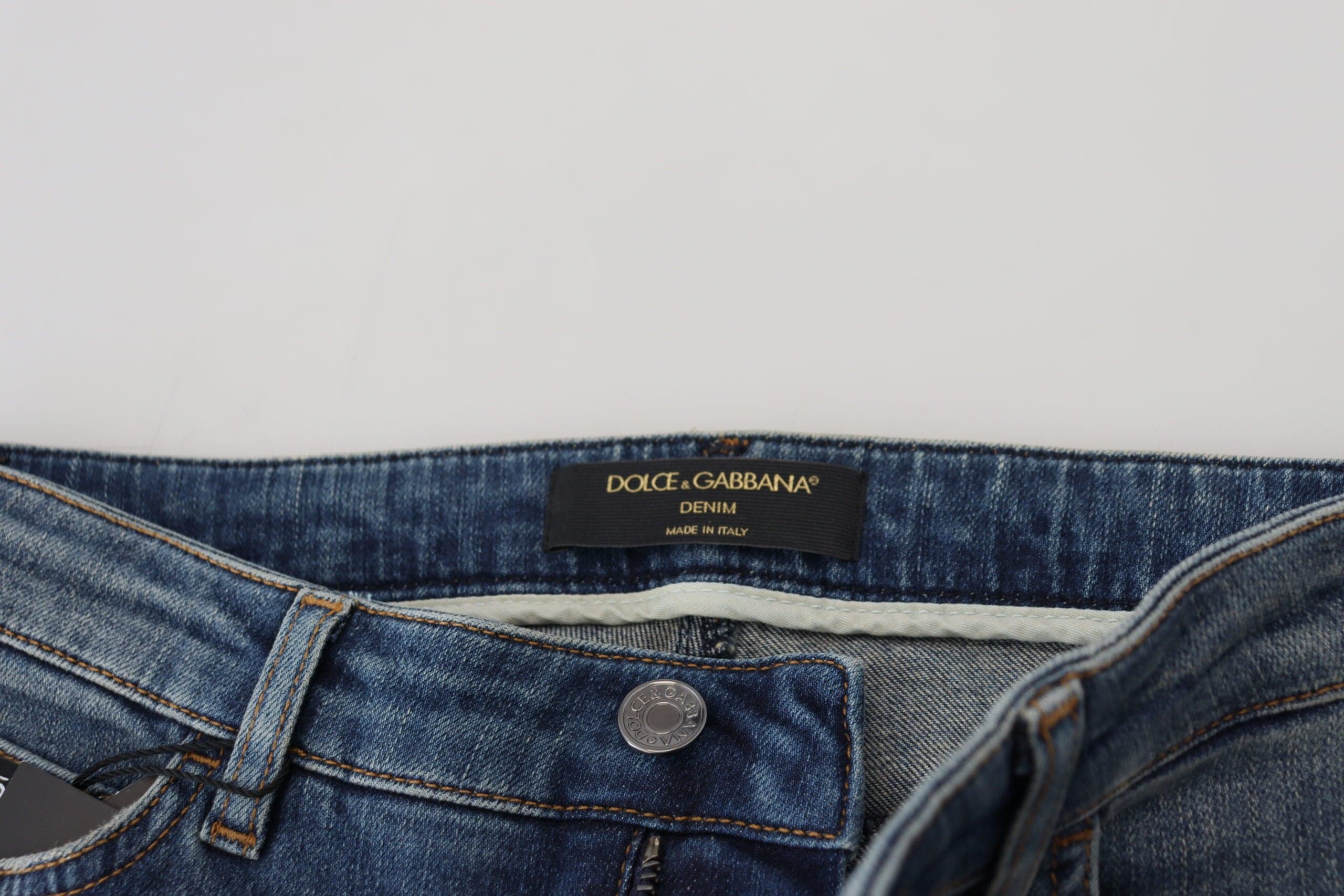 Jeans en denim délavé bleu Dolce & Gabbana, usés et déchirés, en coton tissé pour un style décontracté.