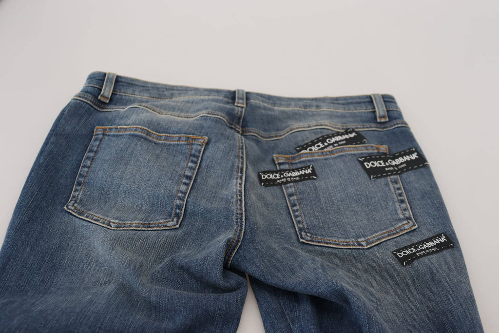 Jeans en denim délavé bleu Dolce & Gabbana avec ourlets déchirés et style décontracté, en coton tissé.