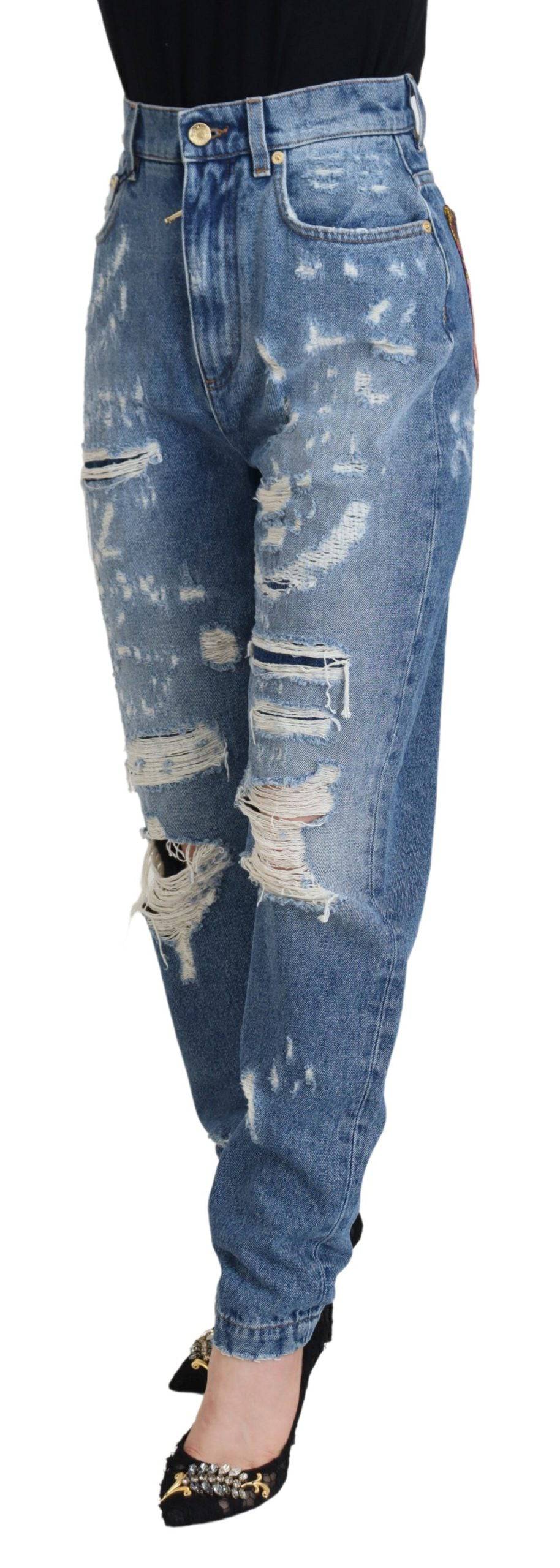 Jeans en denim déchiré en coton lavé bleu de Dolce & Gabbana, style décontracté avec détails usés.