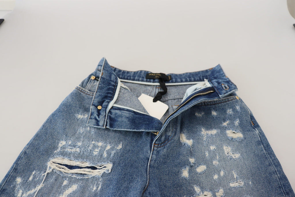 Jeans en denim déchiré en coton lavé bleu de Dolce & Gabbana, style décontracté et tendance.