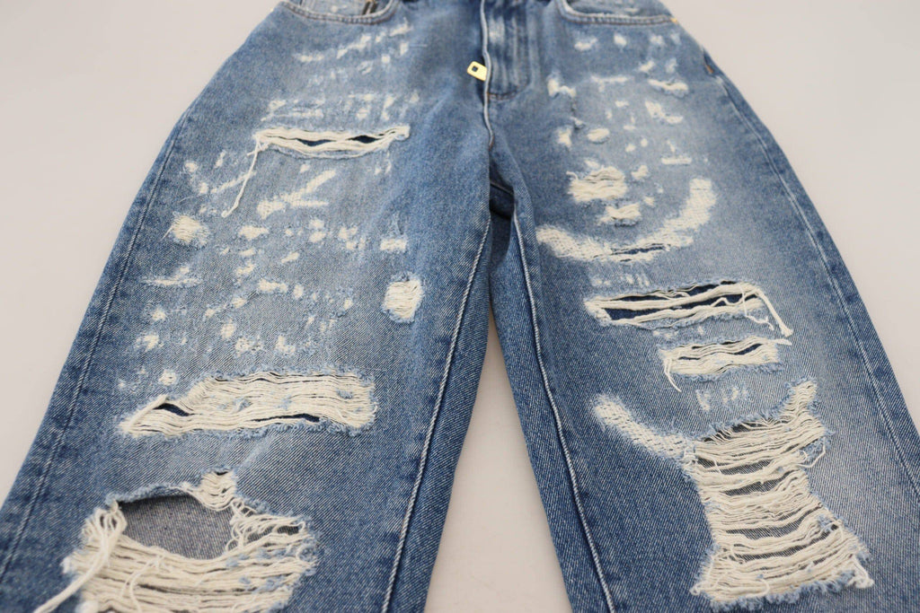 Jeans en denim déchiré bleu en coton lavé de Dolce & Gabbana, style décontracté avec détails usés.