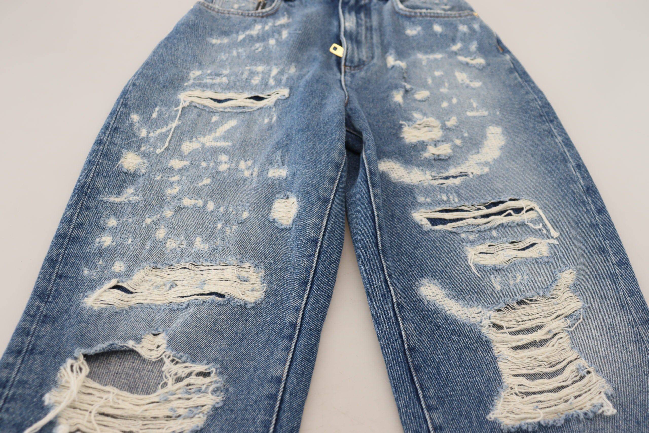 Jeans en denim déchiré bleu en coton lavé de Dolce & Gabbana, style décontracté avec détails usés.