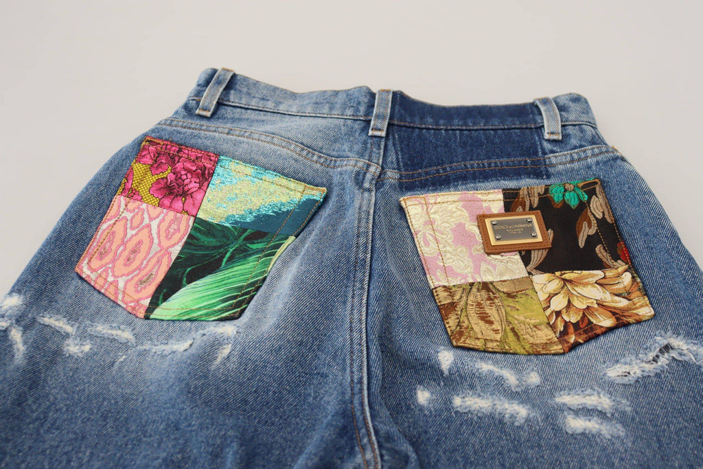 Jeans en denim délavé bleu Dolce & Gabbana, en coton tissé avec un style usé et déchiré, pour un look décontracté et tendance.