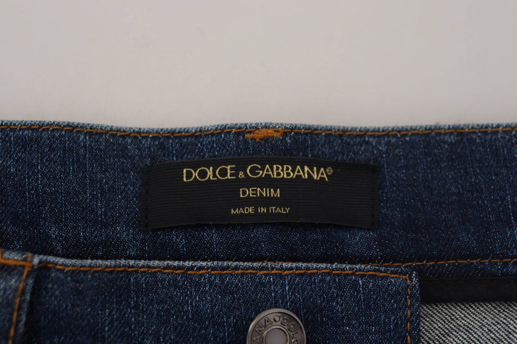 Jeans skinny en denim noir Dolce & Gabbana avec dentelle florale à l'avant, coupe ajustée et détails élégants.