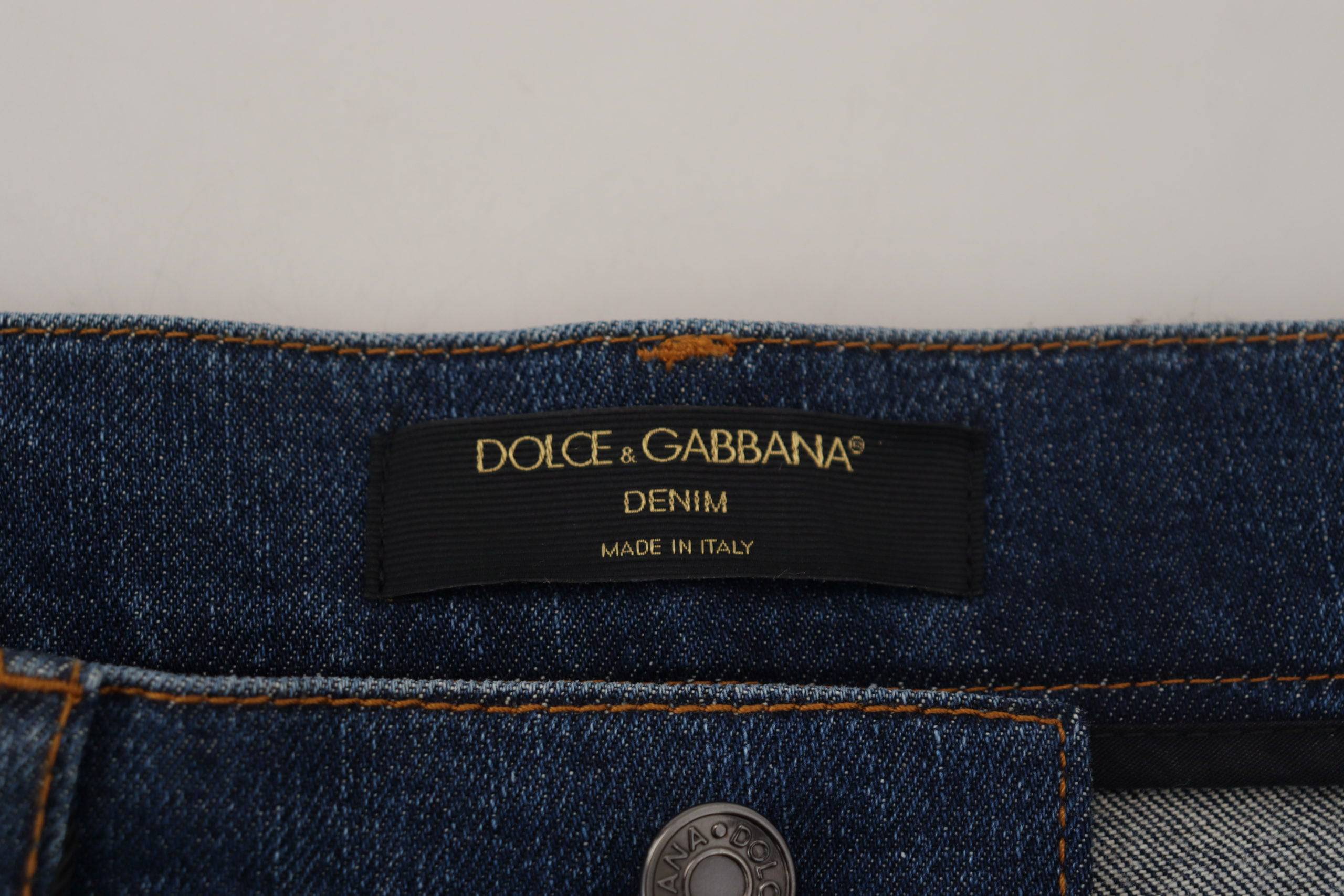 Jeans skinny en denim noir Dolce & Gabbana avec dentelle florale à l'avant, coupe ajustée et détails élégants.