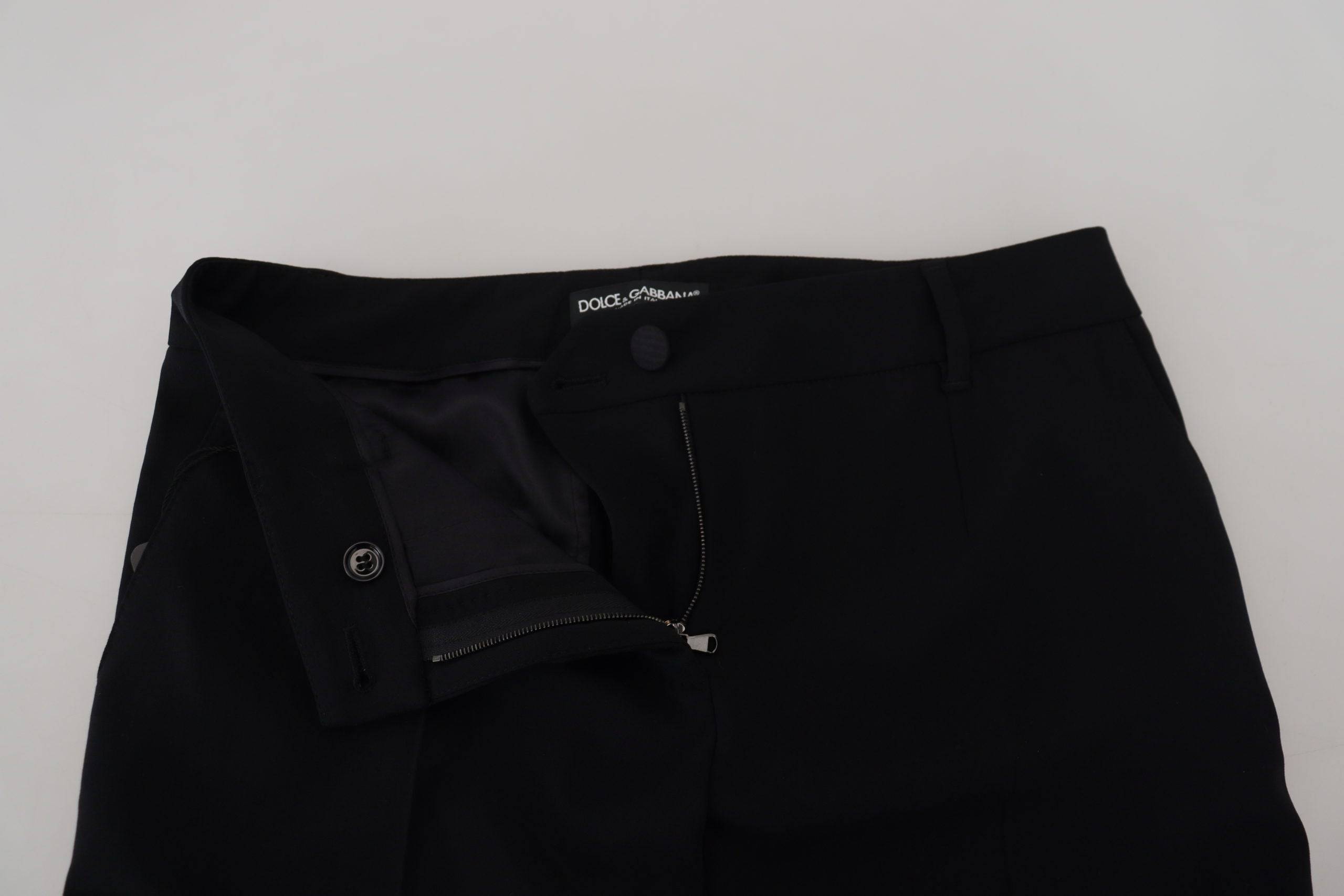 Pantalon en laine noire pour femmes de coupe tapered par Dolce & Gabbana, visible avec détails élégants.