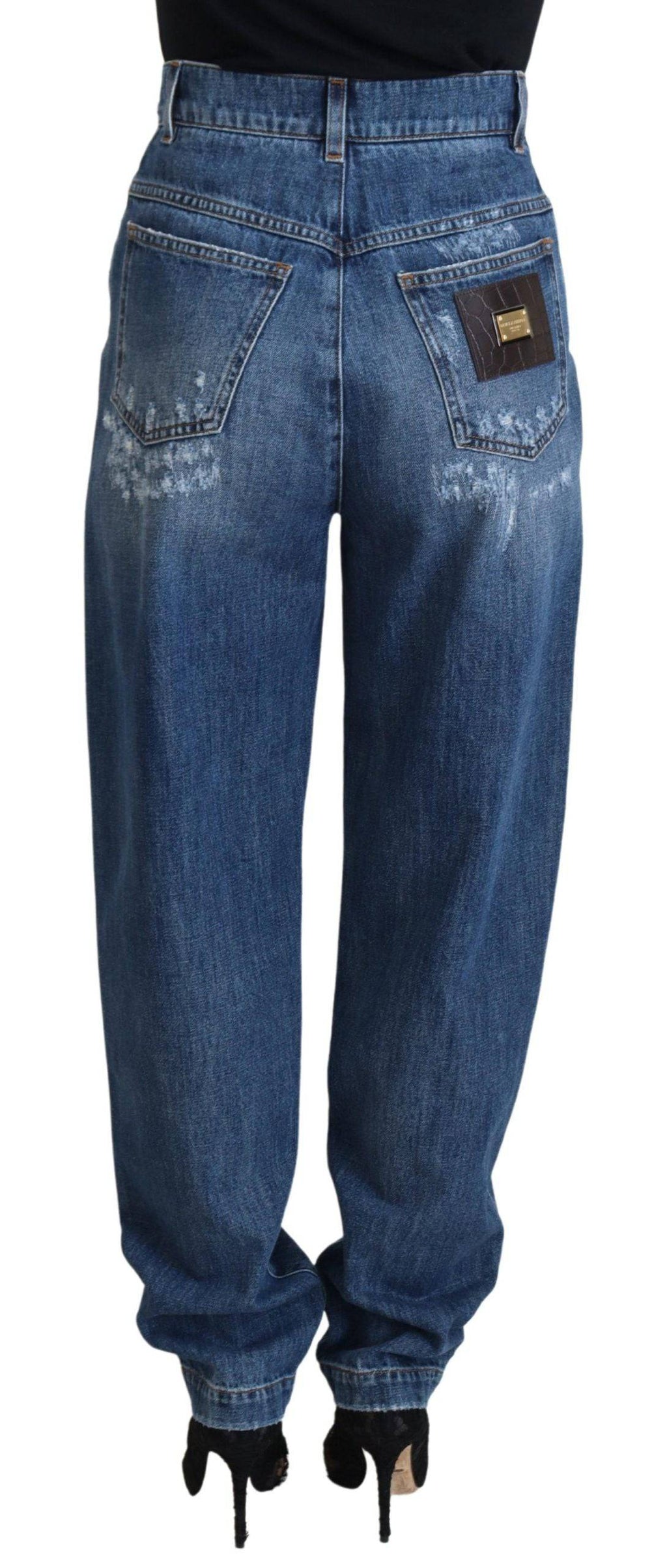 Jeans en denim délavé et usé Dolce & Gabbana, coupe déchirée, en coton bleu, style tendance et décontracté.