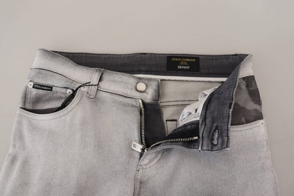 Jeans skinny homme Dolce & Gabbana gris délavé en denim, ajustés et modernes, visibles sur l'image.