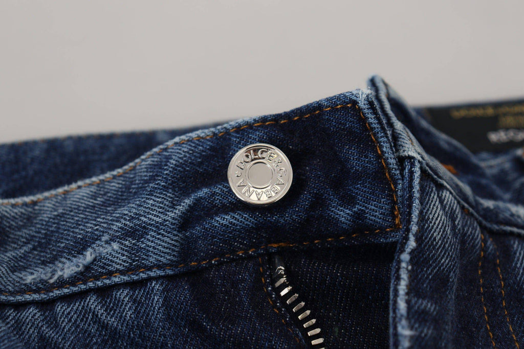 Jeans en denim bleu pour homme de Dolce & Gabbana, coton avec déchirures et style décontracté, visibles sur l'image.