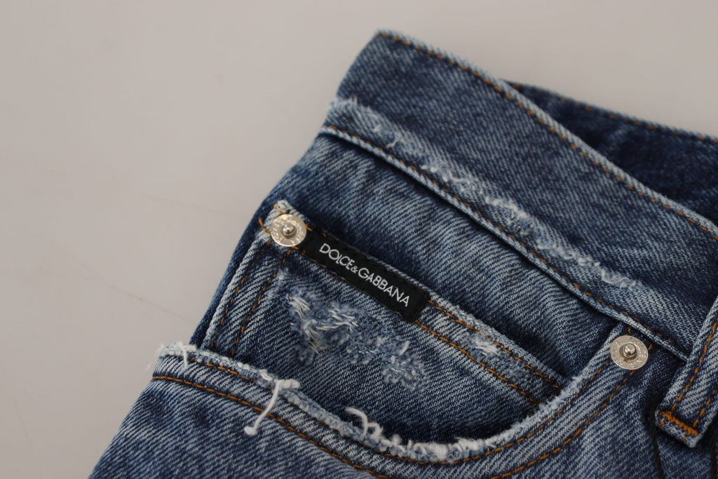 Jeans homme en coton bleu déchiré de Dolce & Gabbana, denim tattered avec style moderne et détails usés.