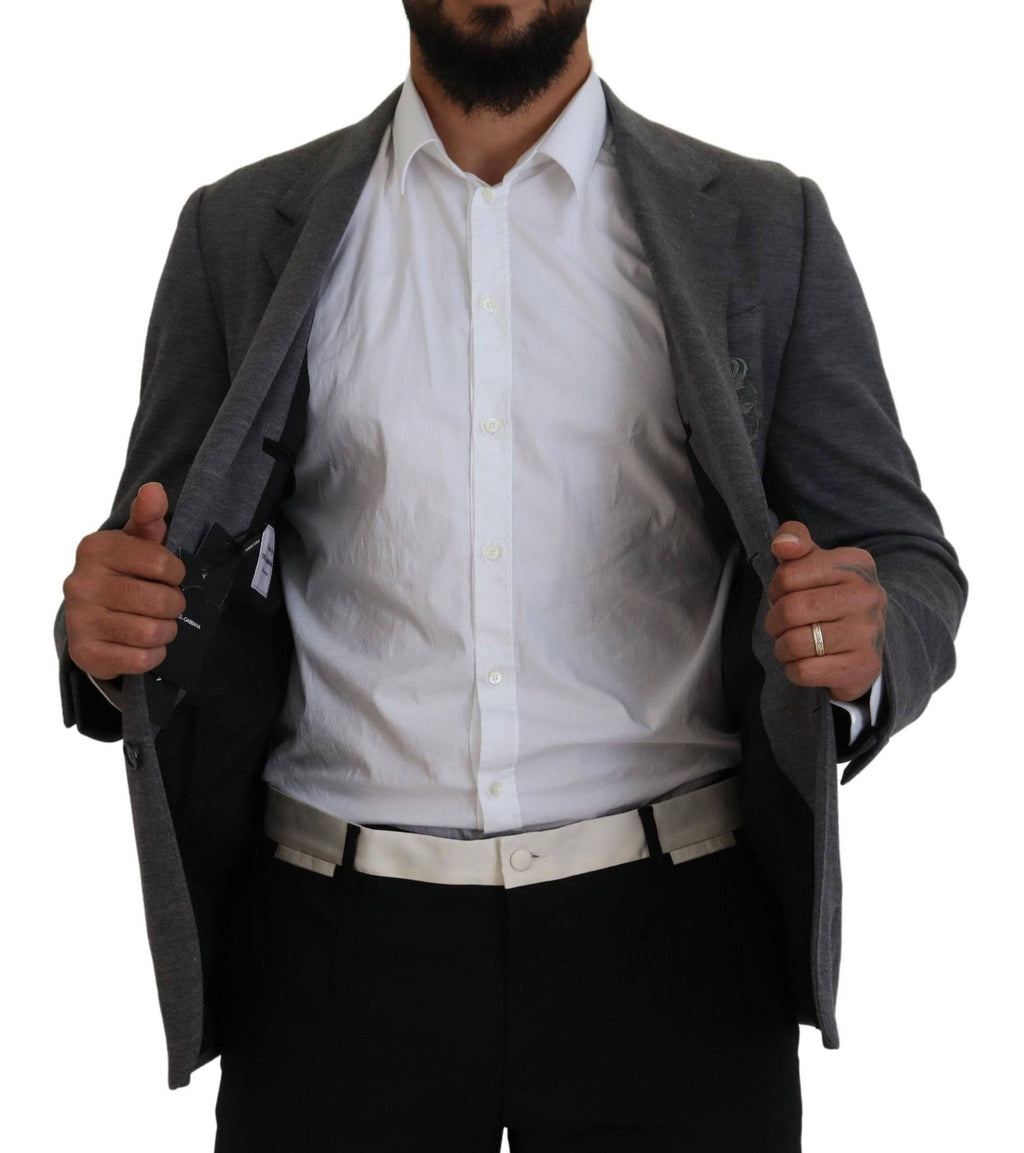 Veste blazer gris en laine stretch Dolce & Gabbana, coupe slim fit, élégante et sophistiquée, portée sur un mannequin.