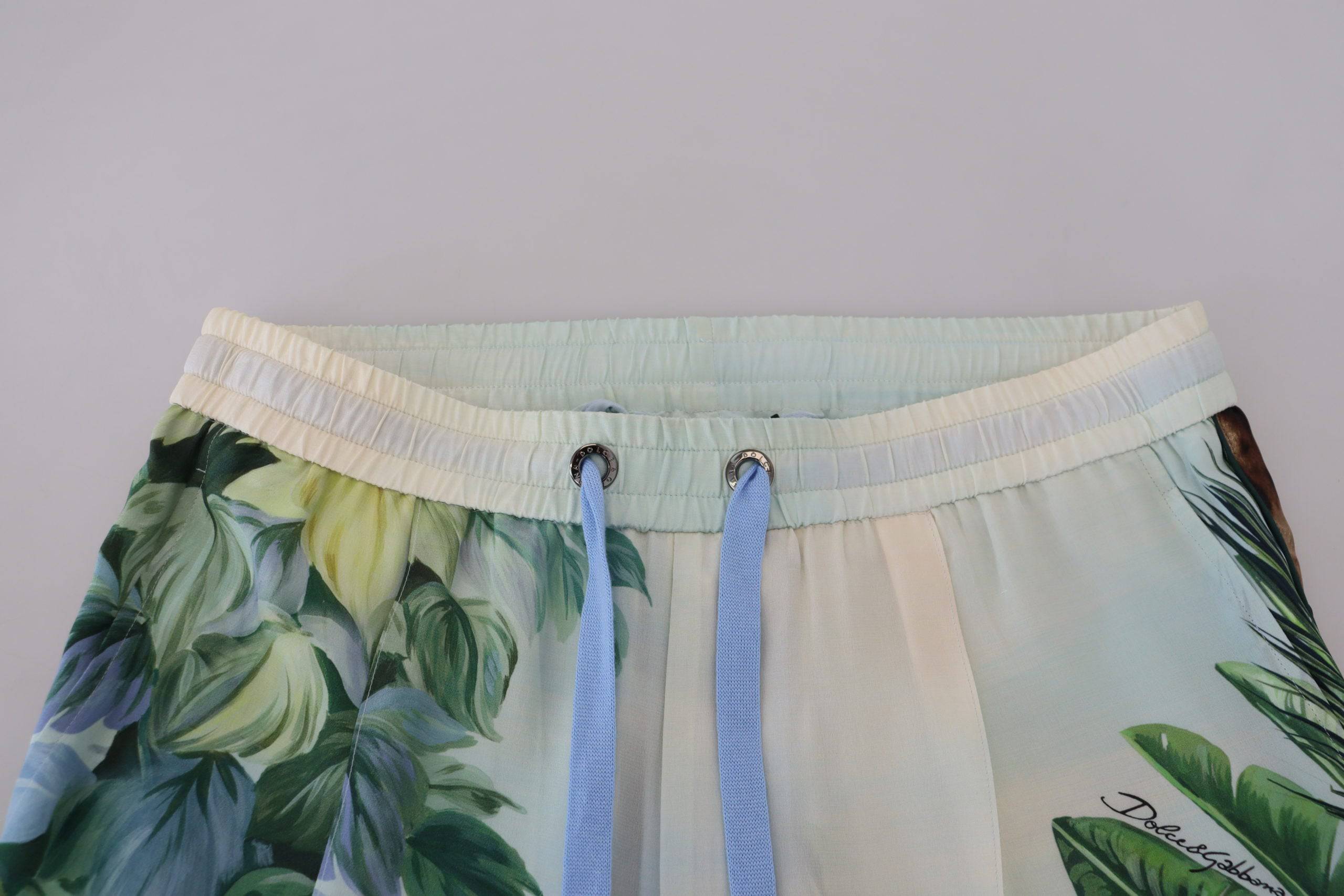 Pantalon jogging homme blanc à fleurs Dolce & Gabbana avec motif floral, tissu léger et ajustement confortable.