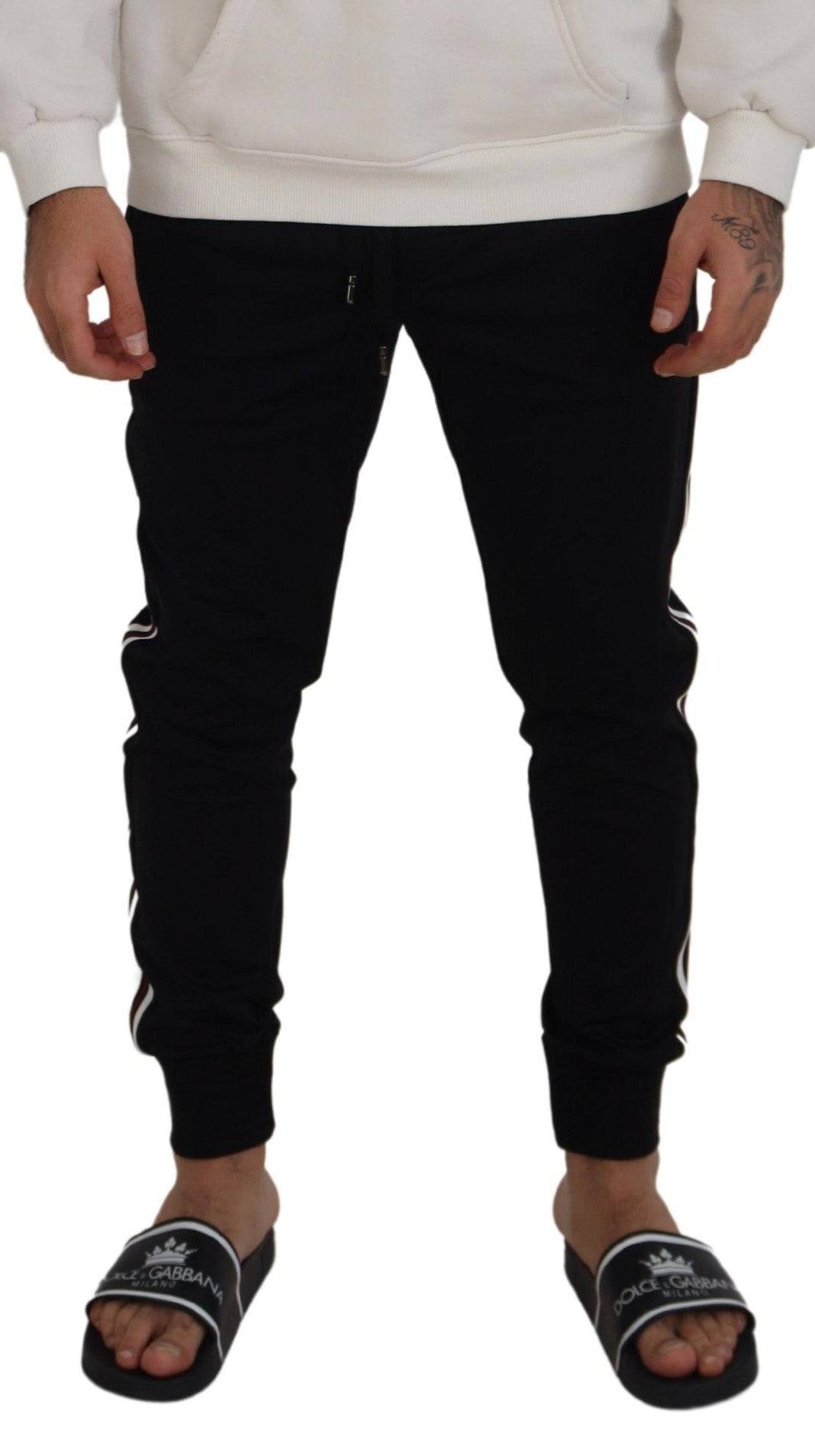 Pantalons jogger pour homme Dolce & Gabbana noirs avec motif DG, confortables, en tissu doux, visible en gros plan sur l'image.