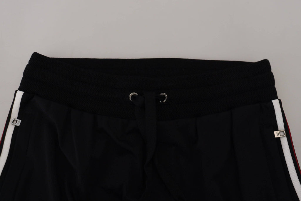 Pantalon jogger noir pour homme Dolce & Gabbana avec imprimé DG, tissu décontracté et style moderne.
