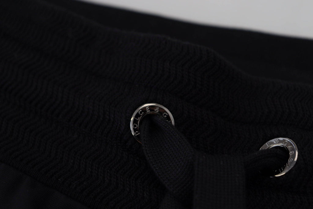 Pantalon de jogging noir pour homme Dolce & Gabbana avec motif DG imprimé, tissu confortable et style décontracté.