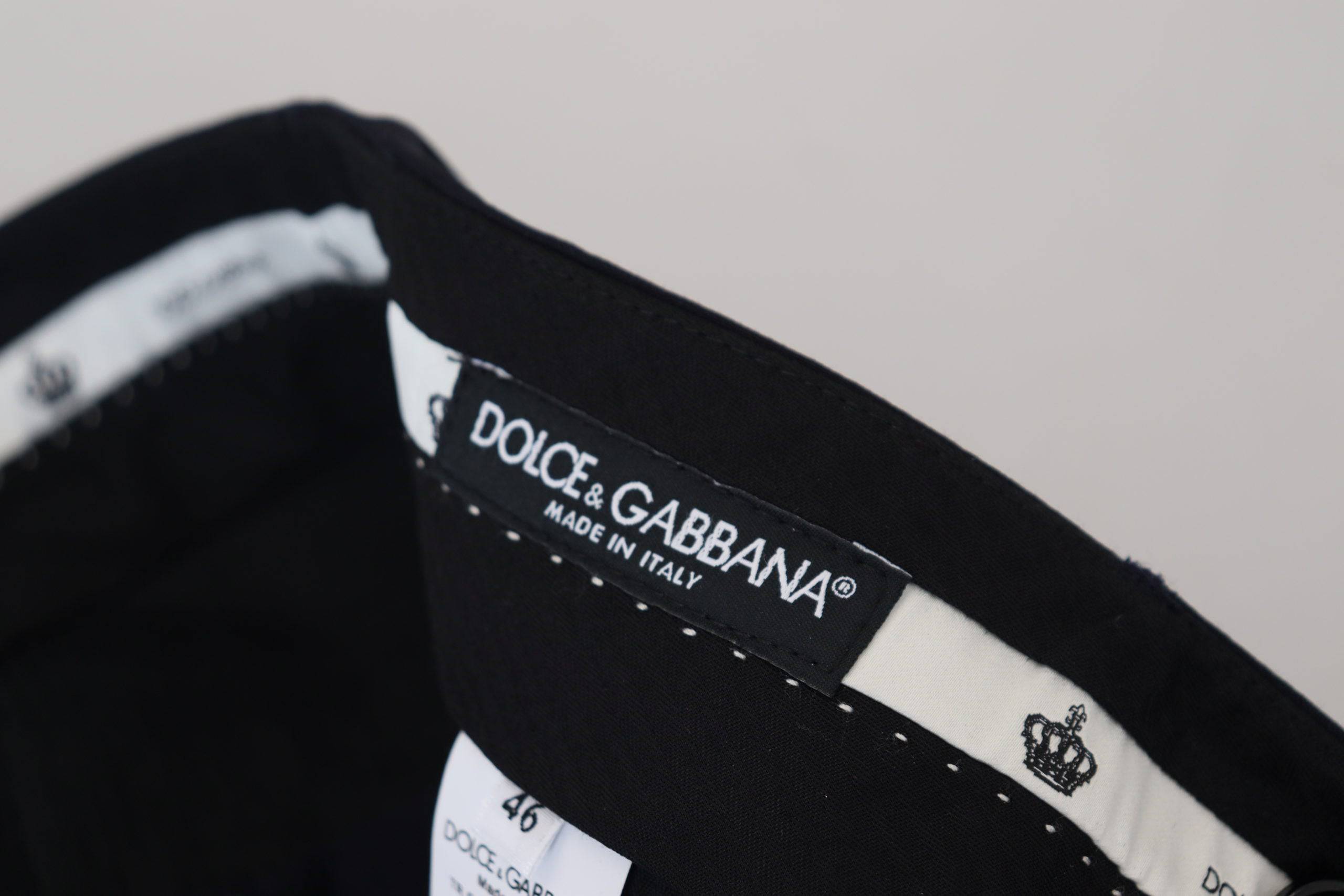 Pantalon de costume noir en laine Dolce & Gabbana, coupe slim, élégant et formel, visible en détail sur l'image.