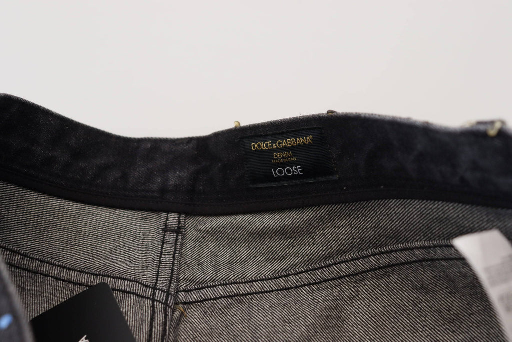 Jeans en denim déchiré noir à imprimé multicolore de Dolce & Gabbana, style tendance et détails usés.