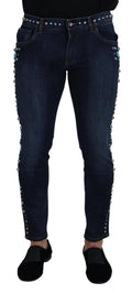 Jeans en denim bleu Dolce & Gabbana à taille basse, ornementés de clous, pour un style décontracté et tendance.