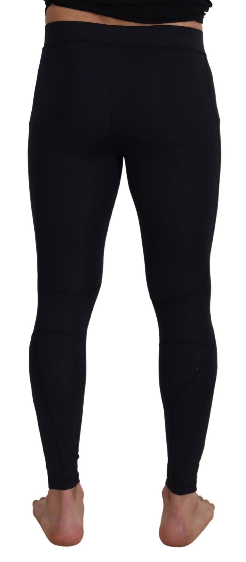 Pantalons slim en nylon noir de Dolce & Gabbana, coupe ajustée et stretch, visibles en gros plan.