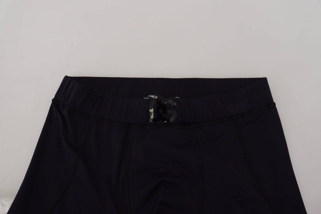 Pantalons slim en nylon noir Dolce & Gabbana, coupe ajustée et stretch, visibles en détail dans l'image.
