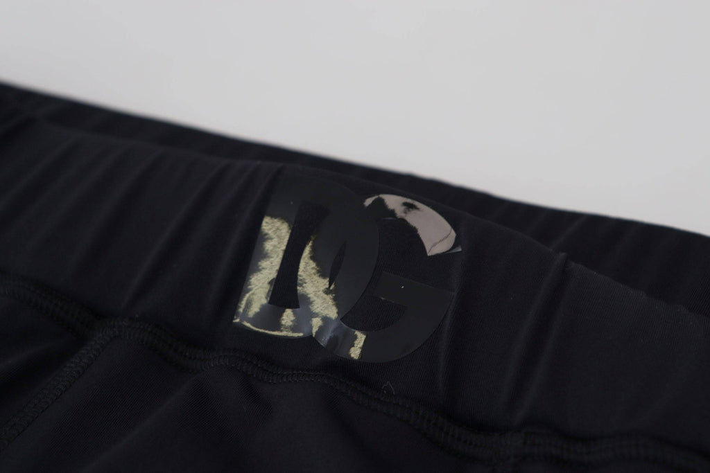 Pantalon noir en nylon extensible slim fit de Dolce & Gabbana, style élégant et moderne, visible avec poches et détails fins.