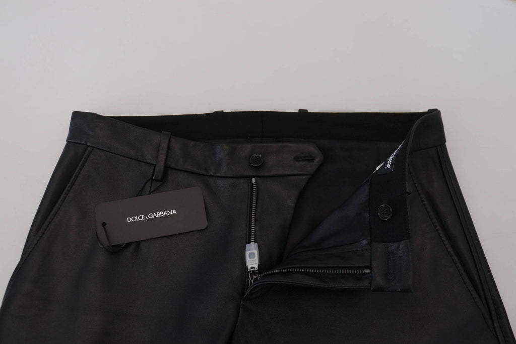 Pantalons skinny noirs brillants en stretch de Dolce & Gabbana, ajustés et élégants, visibles en gros plan.