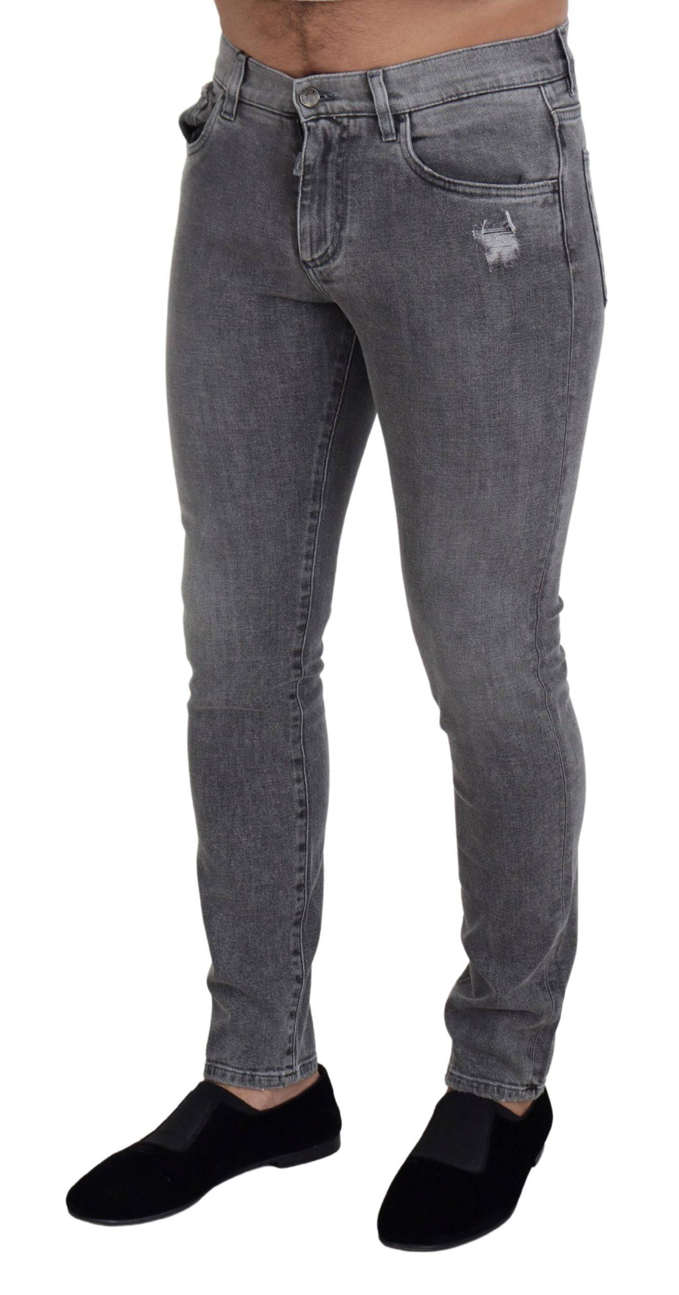 Jeans skinny en denim gris délavé de Dolce & Gabbana en coton, ajustés et modernes, visibles sur l'image.