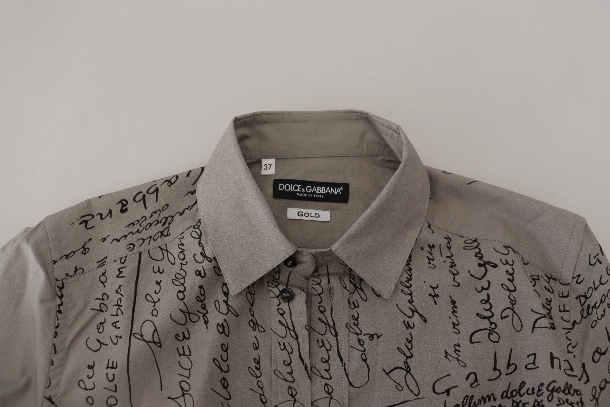Robe slim en coton gris imprimé de Dolce & Gabbana avec détails dorés, élégante et moderne.