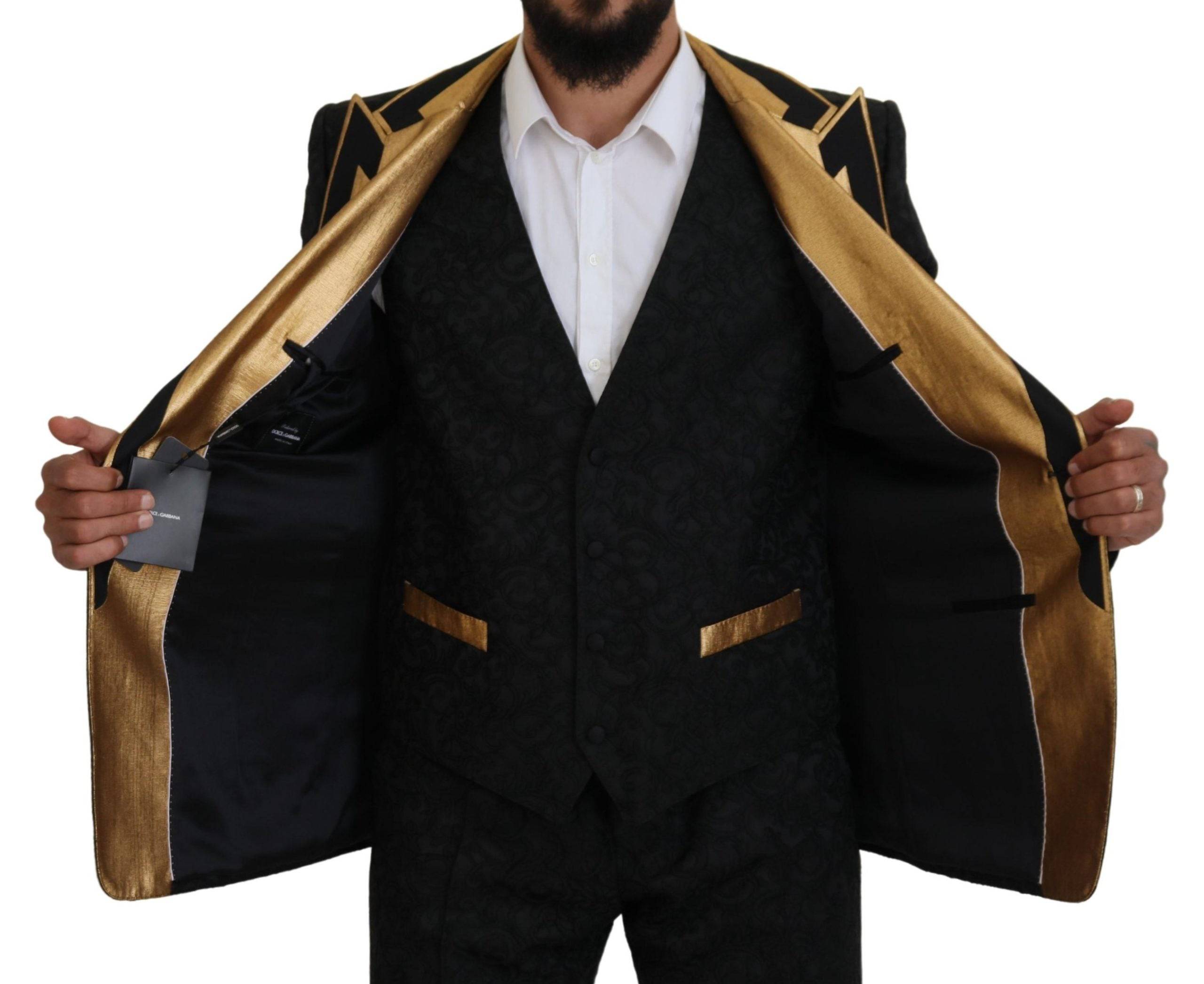 Costume tuxedo slim fit noir et or Dolce & Gabbana avec détails fantaisie, élégant et sophistiqué.