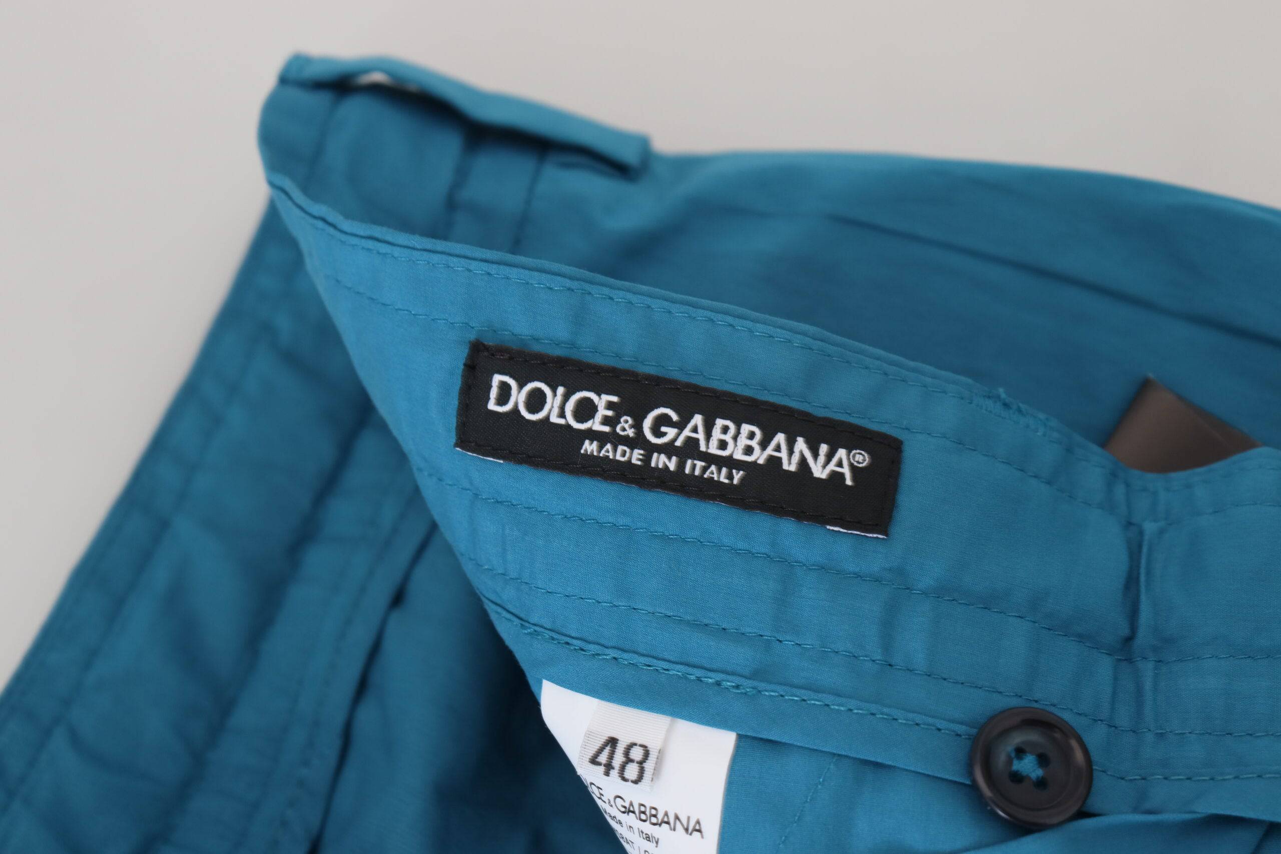 Pantalon chino en coton bleu Dolce & Gabbana, coupe élégante, porté sur un mannequin avec détails visibles.
