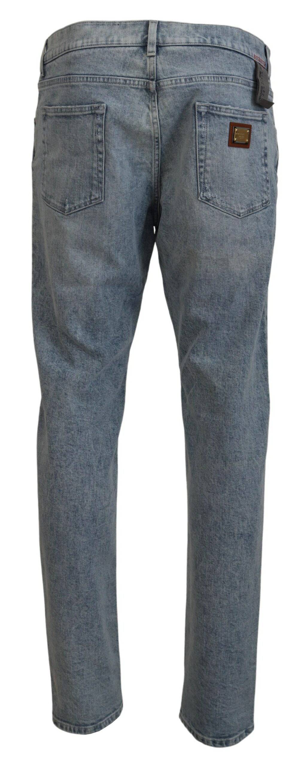 Jeans en denim bleu Dolce & Gabbana, coupe slim fit, en coton, visibles avec une fermeture éclair et des poches avant.