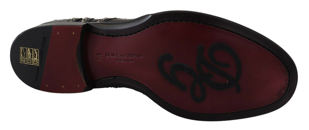 Chaussures derby en cuir noir Dolce & Gabbana avec détails cloutés et design élégant visible sur l'image.