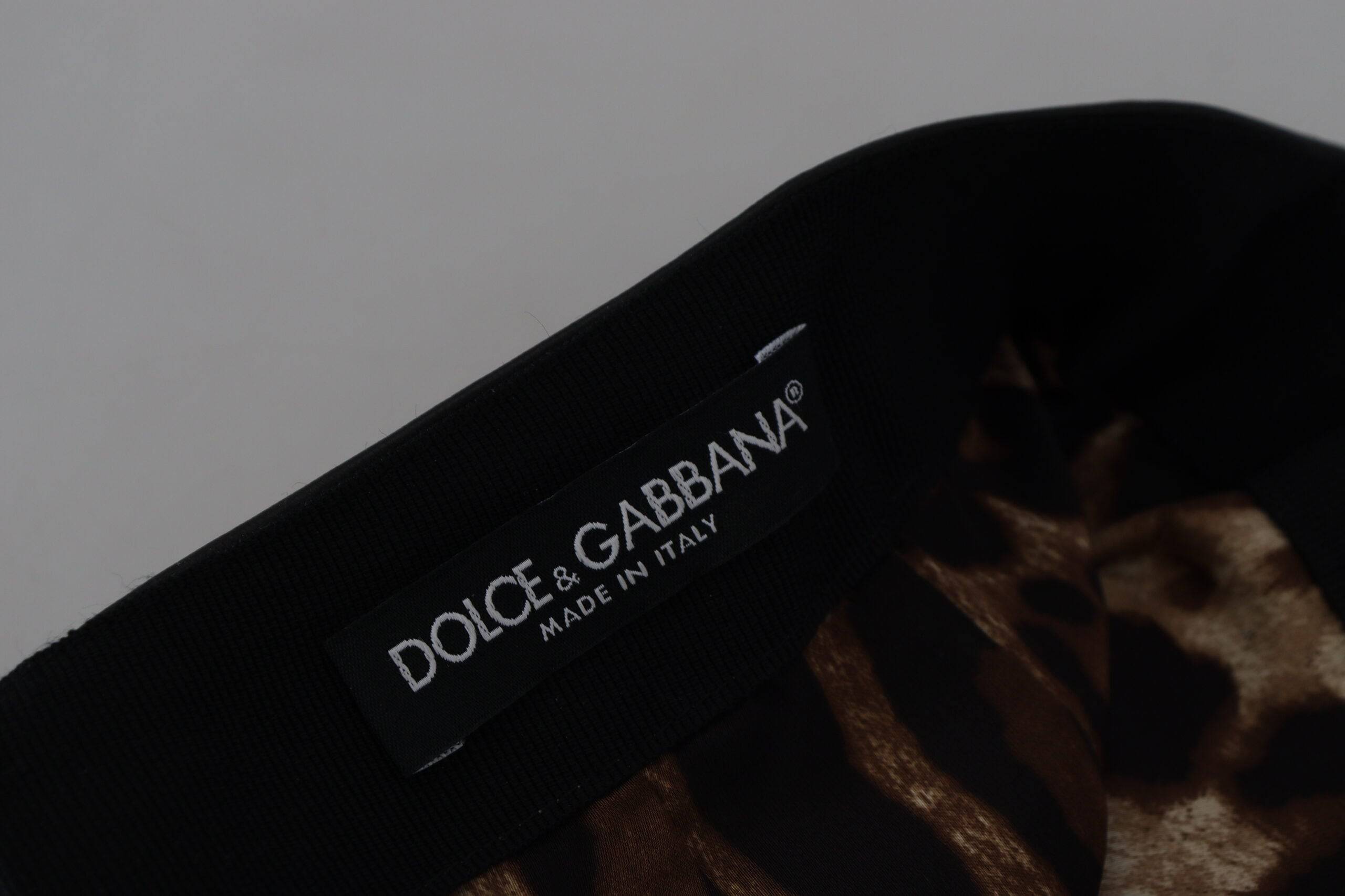 Mini jupe en cuir d'agneau noir Dolce & Gabbana, coupe en A élégante, vue de face sur un fond neutre.