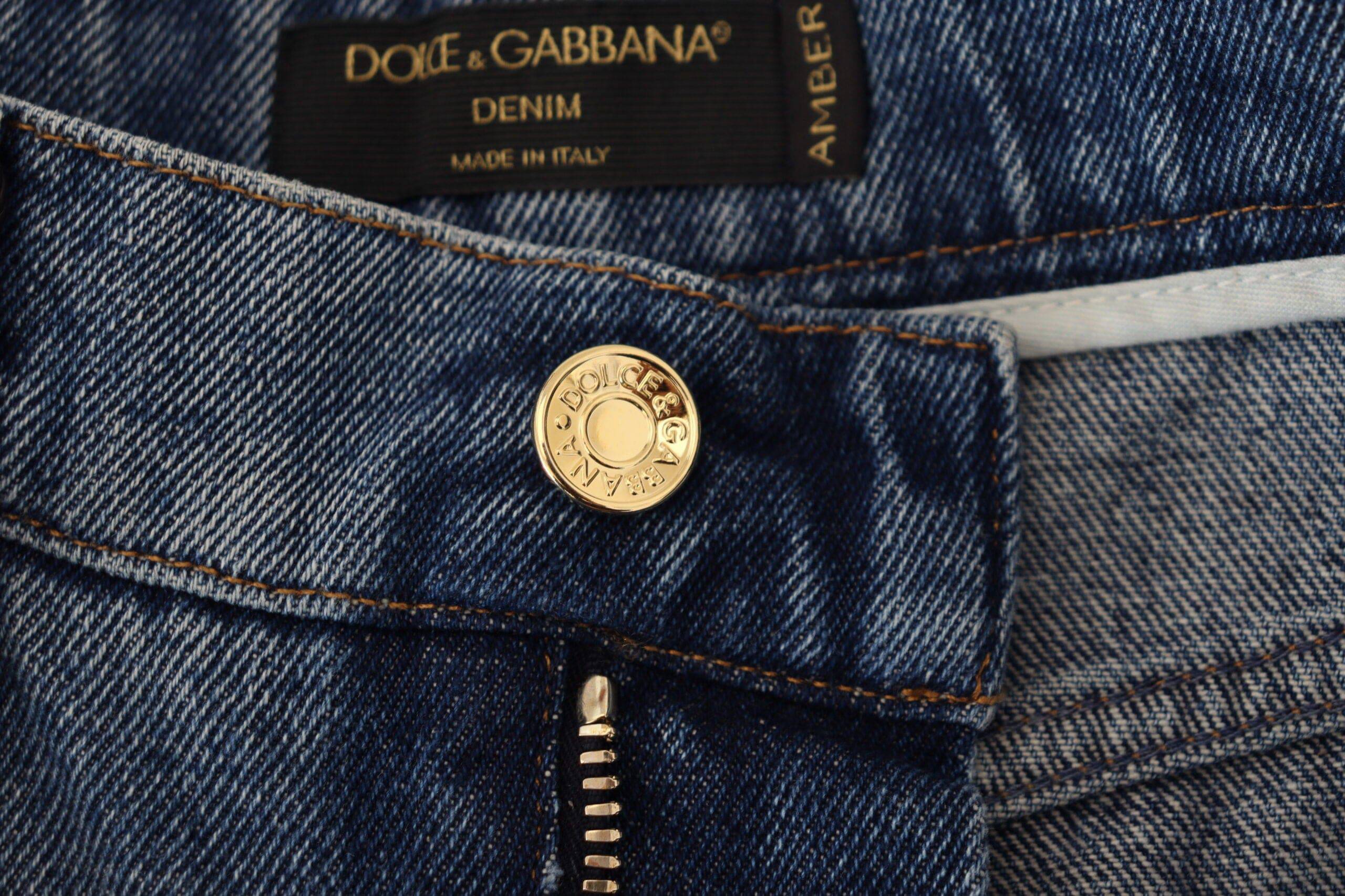 Jean skinny en denim coton bleu déchiré de Dolce & Gabbana, style tattered et tendance, porté avec détails usés visibles.