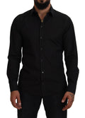Chemise noire Dolce & Gabbana en coton avec col, manches longues et détails dorés visibles sur l'image.