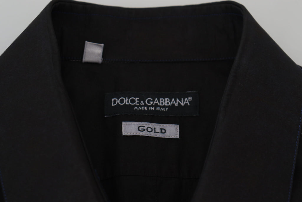 Chemise longue noire en coton Dolce & Gabbana avec col et manches longues or, élégante et sophistiquée.