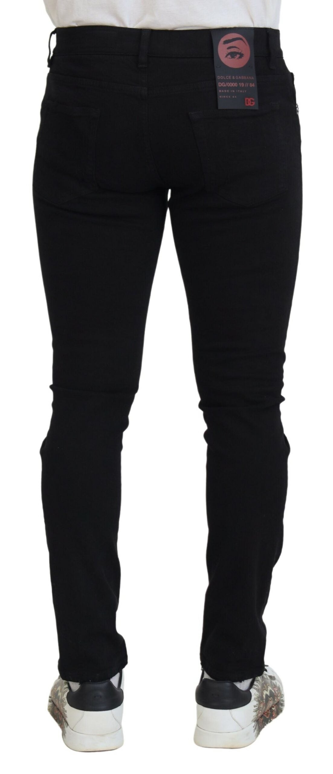 Jeans en denim noir Dolce & Gabbana Slim Fit tachetés, en coton avec déchirures, visage visible, style décontracté et tendance.