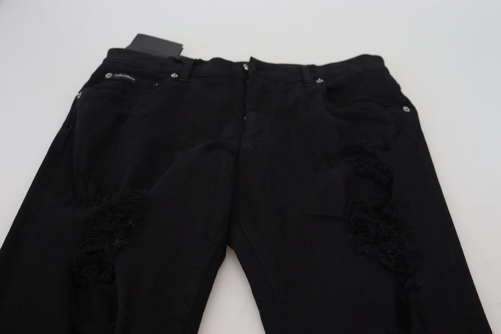 Jeans en denim noir Dolce & Gabbana, coupe slim, avec déchirures et couture en coton, mode tendance pour homme.