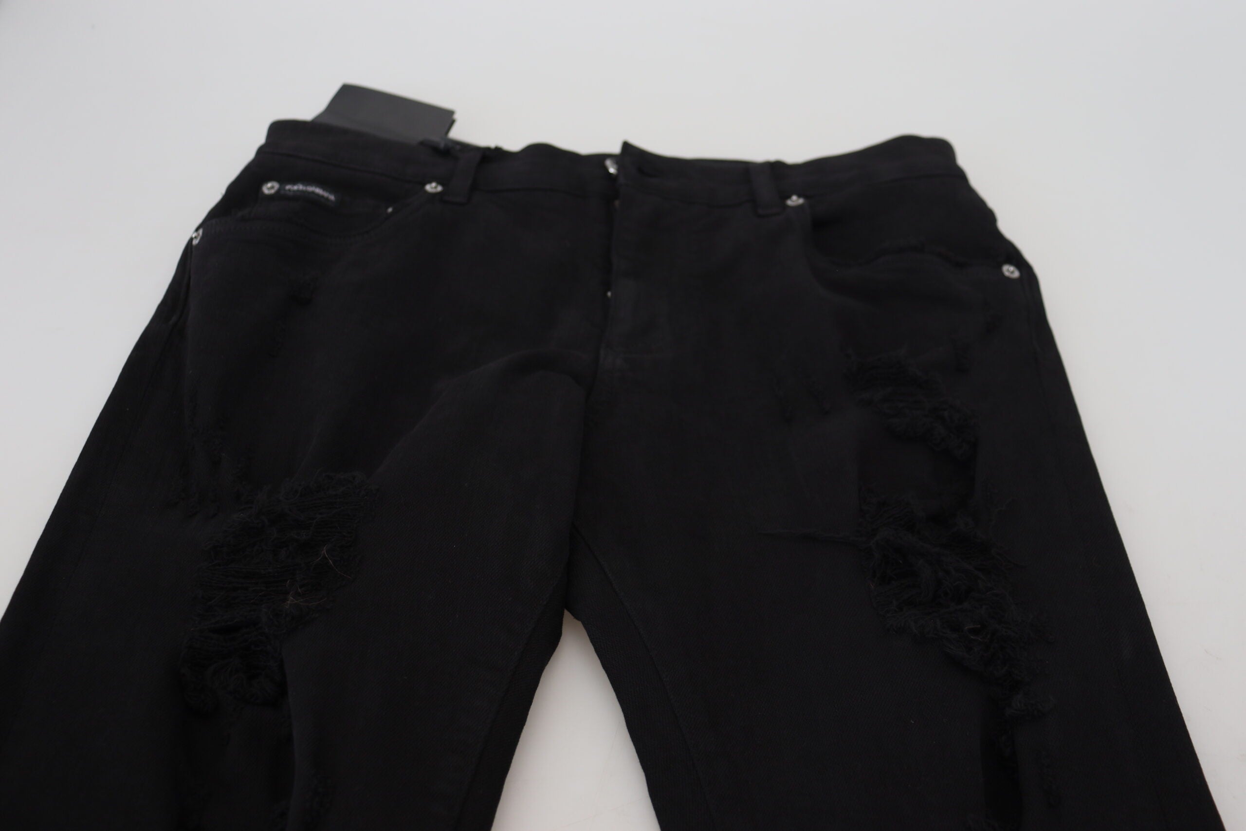 Jeans en denim noir Dolce & Gabbana, coupe slim, avec déchirures et couture en coton, mode tendance pour homme.