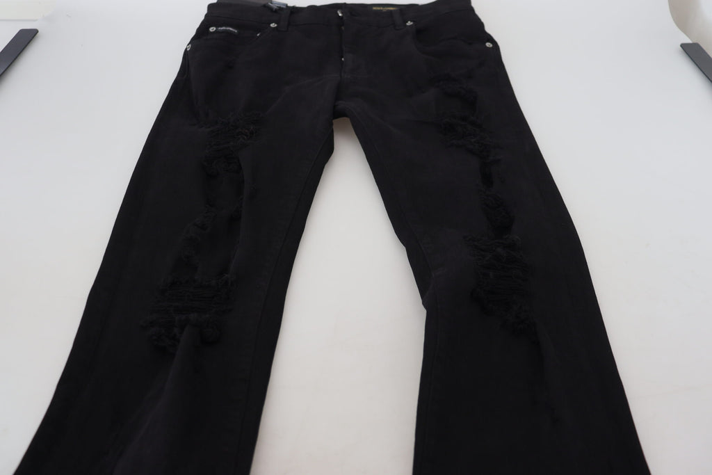 Jeans en denim noir Dolce & Gabbana, coupe slim, avec déchirures et détails tachetés, en coton.