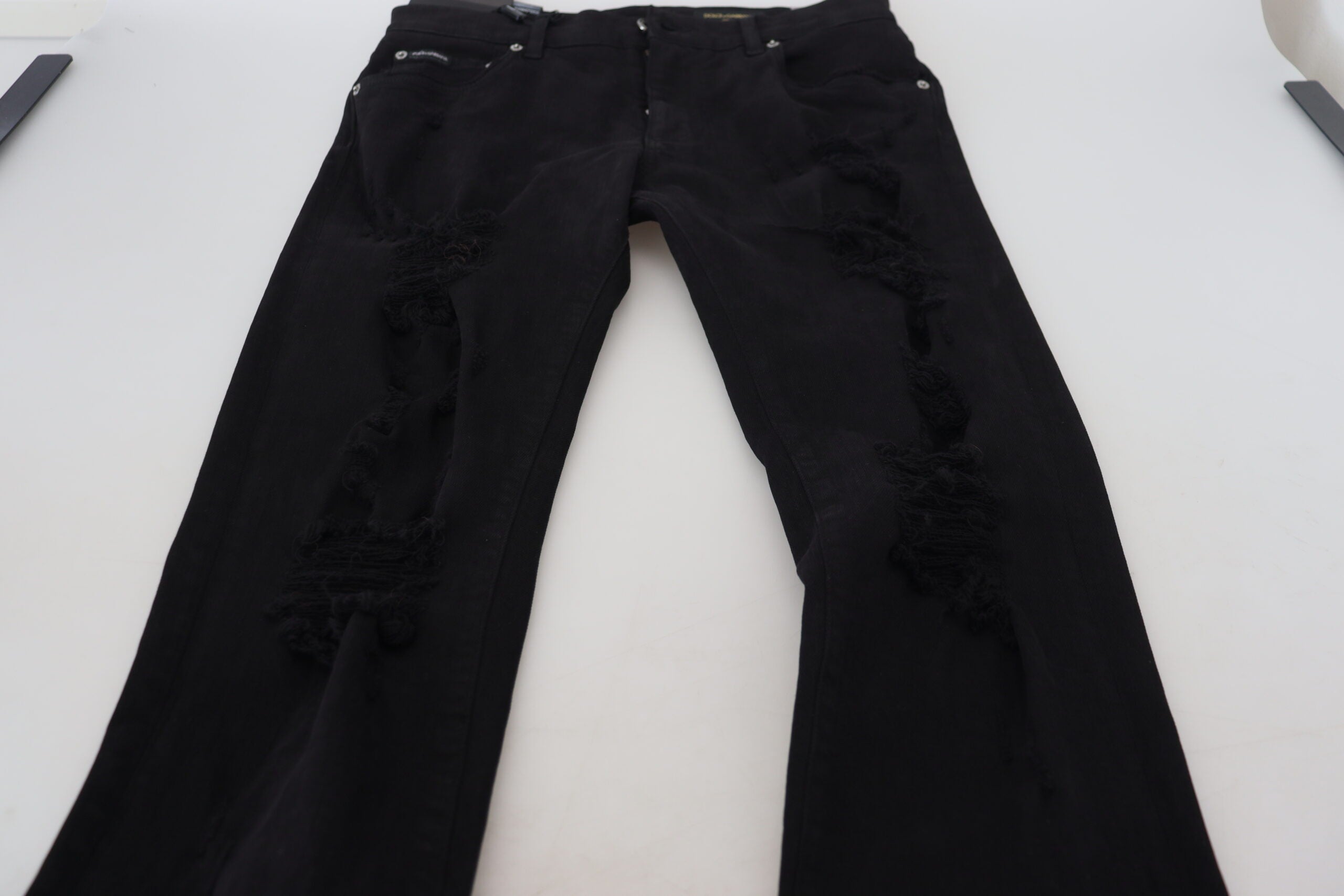 Jeans en denim noir Dolce & Gabbana, coupe slim, avec déchirures et détails tachetés, en coton.