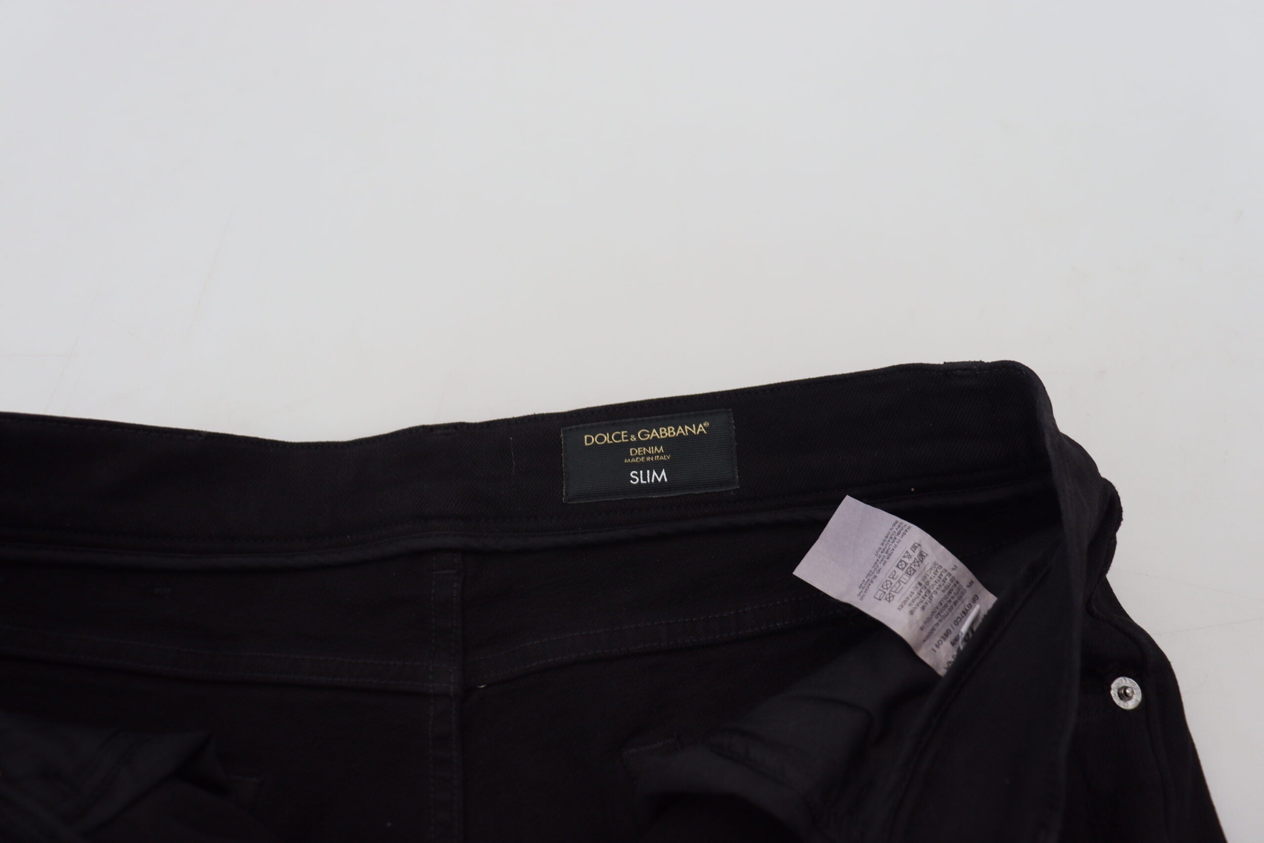 Jeans en denim noir slim fit tattered de Dolce & Gabbana, en coton avec déchirures stylisées.