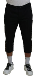 Pantalons courts en coton noir Dolce & Gabbana avec taille élastique et logo DG visible, style décontracté et tendance.