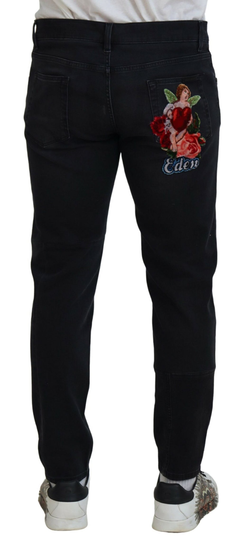 Jeans skinny en denim noir Dolce & Gabbana avec broderie d'ange, détails élégants et coupe ajustée.