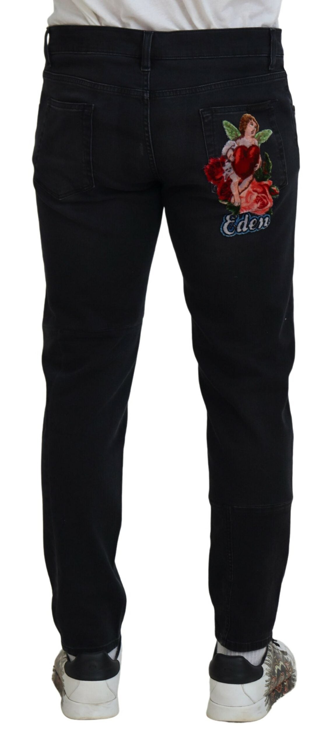 Jeans skinny en denim noir Dolce & Gabbana avec broderie d'ange, détails élégants et coupe ajustée.
